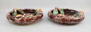 A pair of Continental shallow dishes, 20th century, decorated with brown glazes, applied to the rims with orange flowers, 36cm diameter, together with a large 