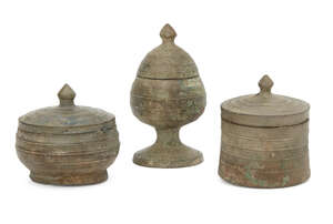 Three Chinese bronze miniature votive covered vessels, Late Six dynasties - Early Tang dynasty, one formed as a lotus bud on a pedestal base, another of compre
