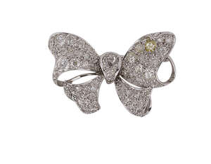 
	
		A diamond bow brooch, the ribbon bow with pave old-brilliant-cut diamonds and diamond two...