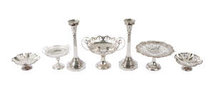 A pair of silver candlesticks, London c.1946, A Taite & Sons Ltd (probably) the square tapering stems on domed base with octagonal foot, with un-associated rem