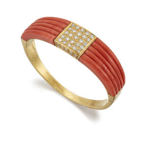 
	
		A coral and diamond bangle, of hinged half-hoop design, the central brilliant-cut diamond...