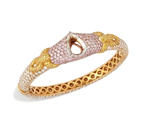 Graff. A diamond and coloured diamond bangle, with a central vacant pear-shaped collet, to...