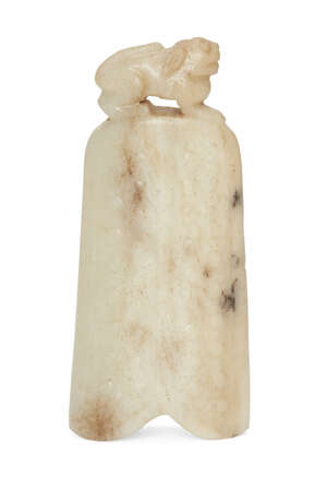 
	
		A Chinese greyish-white jade archaistic pendant, late Qing dynasty, carved as a lion atop...