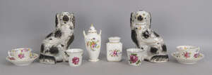 A pair of Staffordshire pottery spaniels, 19th century, decorated with black splash designs, 26cm high, together with a Royal Crown Derby porcelain jar and cov