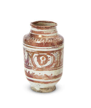 
	
		A small copper-lustre decorated albarello, Kashan, Iran, late 12th century, on a short...