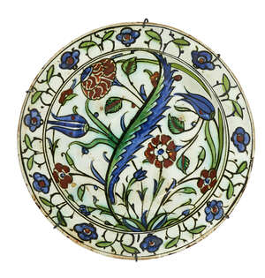 
	
		An Iznik pottery dish, Turkey, 17th century, of shallow rounded form on a short foot with...