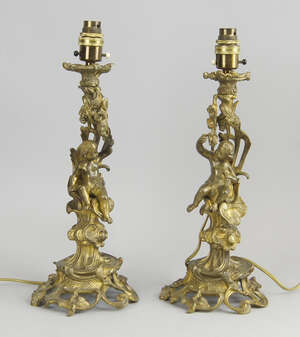 
	
		A pair of Continental gilt bronze candlesticks, 19th century, converted to lamp bases,...