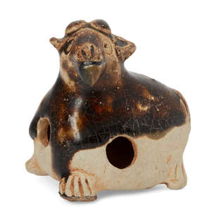 A Chinese pottery whistle in the form of a goat, Tang dynasty, in recumbent pose with four short legs, covered in a crackled treacle glaze stopping midway down