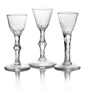 A George III drinking glass, with tapering bowl, cut to the base and stem with facets and octagonal facetted knop, on plain circular foot, 15cm high, together 