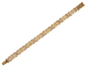 
	
		An Edwardian gold flexible bracelet, of fancy gate-link design with reeded connecting...