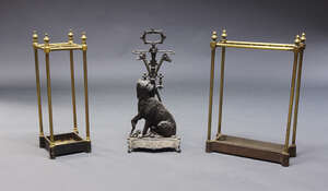 
	
		A spelter metal stick stand, late 19th century, the back in the form of a seated dog with...
