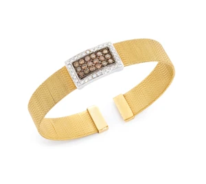 A diamond set torque bangle, with a brilliant-cut diamond and brown diamond set rectangular...