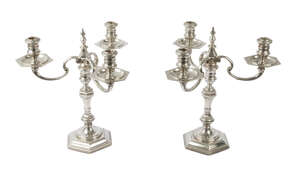 A pair of Georgian style cast silver three branch candelabra, London c.1961, Harrods Ltd (Richard Woodman Burbridge), the hexagonal baluster stem on stepped he