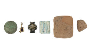 
	
		A group of antiquities comprising an Egyptian glass bead in the form of a vessel, New...