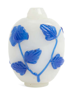 
	
		A Chinese Peking blue-overlay glass snuff bottle, late 19th century, carved with blooming...