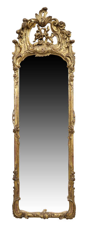 A French rococo gilt wood pier mirror, last quarter 19th century, the floral carved crest with C...