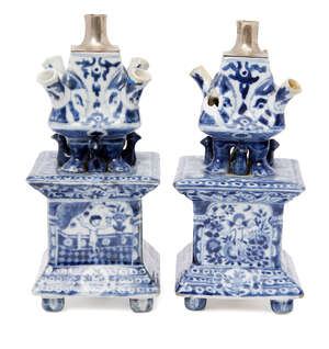 A pair of Chinese porcelain square tulip vases, 18th century, painted in underglaze blue to the main body with four panels depicting a cherub amid floral spray