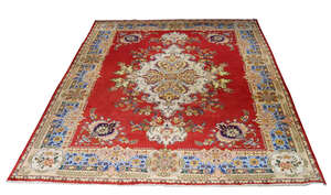 
	
		An Iranian carpet, late 20th Century, with medallion in red ground with blue main border,...