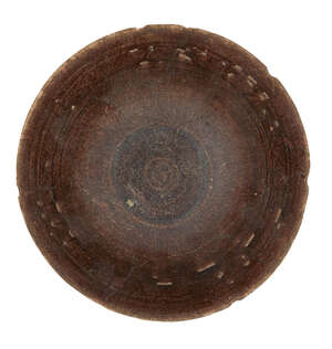 
	
		A manganese glazed bowl, Iran, late 12th-early 13th century, of conical form on a short...