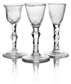 A George III drinking glass, with tapering bowl cut with an Italianate landscape, on facetted cut stem, on circular foot, 15.5cm high, together with a glass wi
