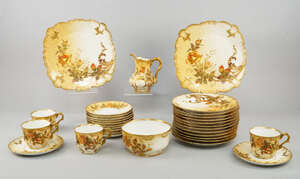 A Limoges taste porcelain part tea/coffee service, of Goa pattern, 20th century,  decorated with trailing flowers, to comprise twelve tea plates, eleven saucer