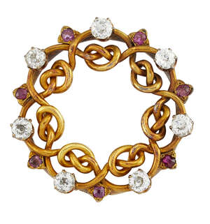 
	
		 A late 19th century Russian gold, diamond and ruby brooch, of entwined garland design...
