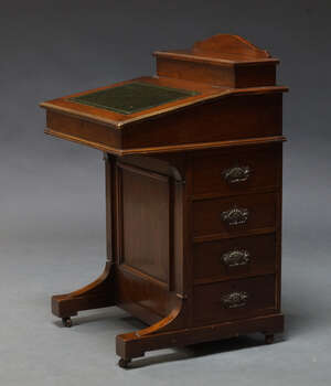 
	
		An Edwardian mahogany Davenport, the top with fitted superstructure including two glass...