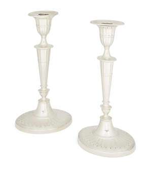 A pair of Victorian silver candlesticks, London, c.1890, William Hutton & Sons., each raised on a spreading oval foot with reeded ring decoration to baluster k