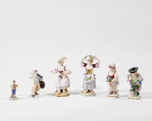 A group of six Meissen and Ludwigsburg porcelain figures, 19th century, blue crossed swords and...