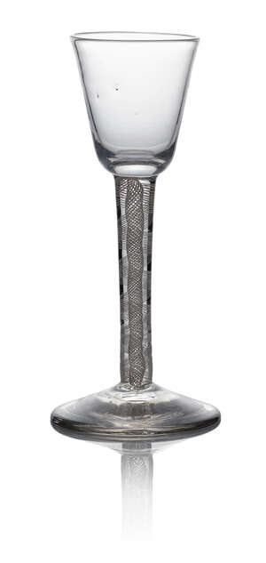 A George III wine glass, c. 1770, with round funnel bowl above double series opaque twist stem standing on conical folded foot, 15cm high