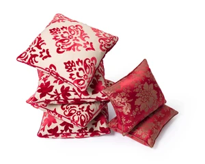 Two pairs of modern crimson cut-velvet cushions, one pair with leafy branches, the other with scroll lozenges; together with a pair of modern silk damask cushi