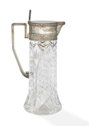 
	
		A silver mounted cut glass water pitcher, bears marks, the cylindrical cut glass body...