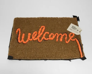 Banksy,&nbsp;British b.1974-&nbsp;Welcome Mat, 2019;&nbsp;hand-stitched welcome mat using the fabric from life...