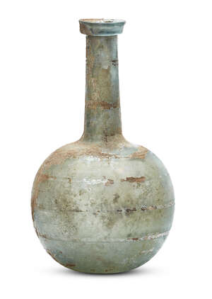 
	
		A Roman bluish-green glass bottle, 1st-2nd century A.D., with a folded collar rim on a...