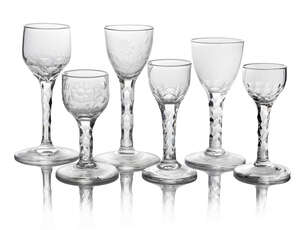 Two George III drinking glasses, both engraved with floral decoration to the bowls, on cut facetted stems with circular bases, 15.5cm and 11cm high, together w