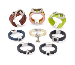 A group of eight rubber rings,&nbsp;in black, brown, clear, green or multi-colour rubber of square,...
