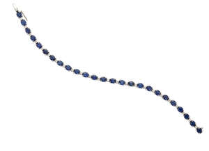 
	
		A sapphire and diamond bracelet, composed of a single line of claw-set oval mixed-cut...