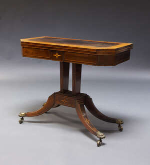 
	
		A Regency rosewood and satinwood crossbanded card table, the fold-over top enclosing...