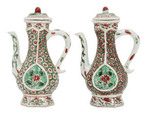 A pair of Chinese porcelain hexagonal ewers and covers for the Islamic market, Kangxi period, painted in famille verte enamels, each pear-shaped ewer is set to