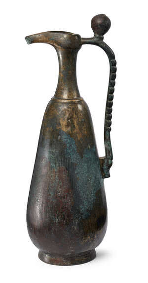 
	
		A Khorassan bronze ewer, North East Iran, 9th-10th century, rising from short foot to...