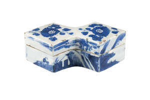 A Chinese porcelain lozenge shaped box and cover, Chenghua mark, Kangxi, painted in underglaze blue to the cover with two chrysanthemum blooms and to the sides