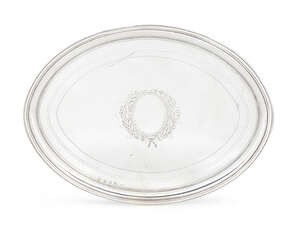 A George III silver teapot stand, Sheffield c.1797, Thomas Law, of naiveté form with bright cut bands and central vacant wreath cartouche, raised on four tape