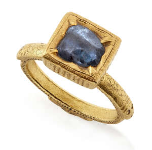 
	
		A South Indian sapphire ring, India, 18th century, the solid gold band engraved to...