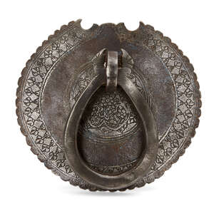 
	
		A Qajar engraved steel door knocker, Iran, 19thcentury, of circular form with crenellated...
