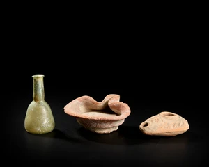 A pottery cocked hat type lamp, circa 1200-900 B.C., 11.5cm max width; a Syro-Palestinian...