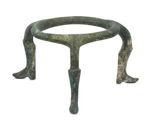 An Amlash bronze tripod, 1st millenium B.C., the ring base atop curved legs running down to boot-form feet, 11cm high
		Provenance: Previously in the collecti