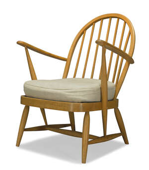 
	
		Ercol, a beech armchair  
		c.1970  
		With hooped spindle back and out swept arms...