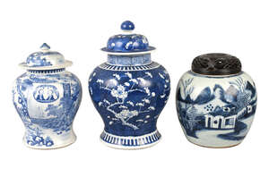 Three Chinese porcelain jars, 18th-19th century, one with cover painted underglaze blue with figures in a garden landscape, 25cm high, another with cover paint