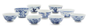 Nine Chinese porcelain wine cups, 18th-19th century, painted in underglaze blue with scenes of coastal landscapes and scholars at leisure, some with underglaze