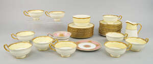 
	
		A Royal Doulton part tea service, 20th century, with yellow banded borders and gilt rims,...